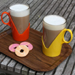 A pair of pyrex glass and plastic retro cups